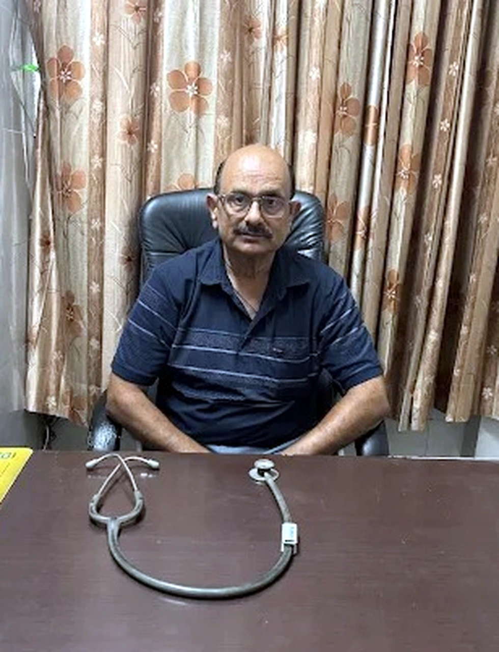 Dr. Rajiv Sharma seated at M.S. Hospital consultation desk